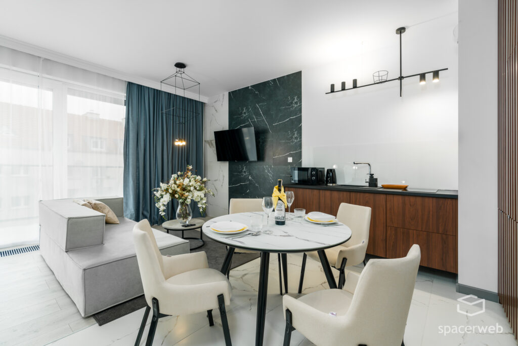 Fotografia wnętrz - Salon ze stołem i aneks kuchenny