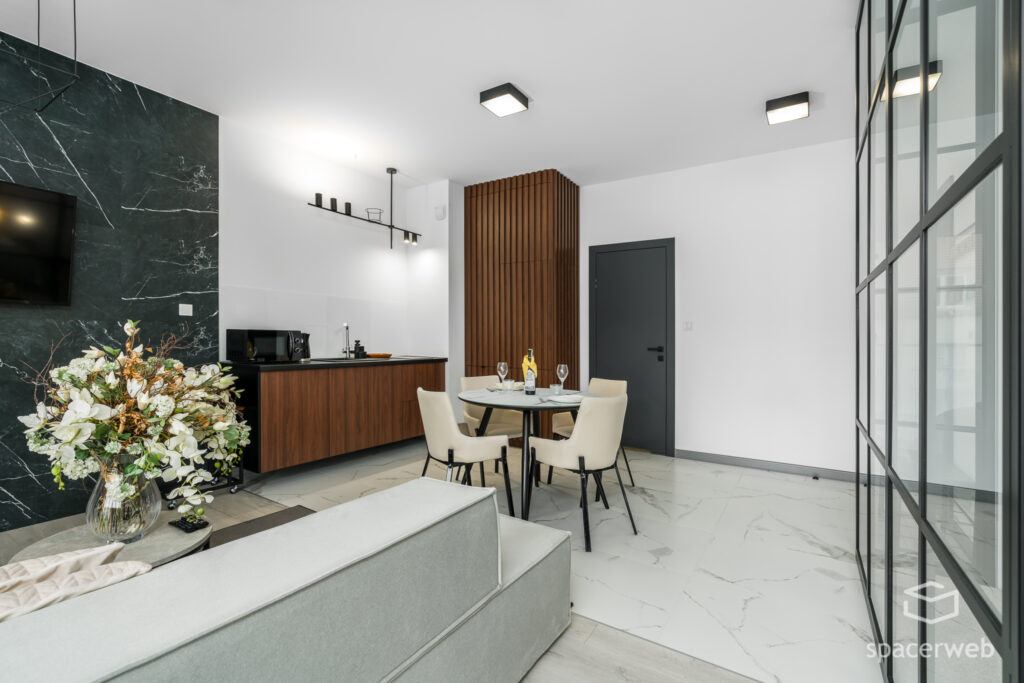 Fotografia wnętrz - Salon ze stołem i aneks kuchenny